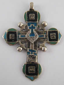 An Orthodox cross in white metal (tests