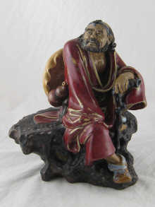 A Chinese ceramic figure of a traveller