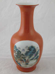 A Chinese ceramic red vase with panels