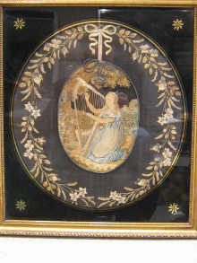 A needlework oval picture of a young