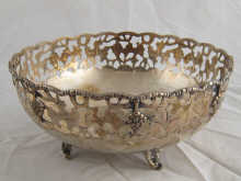 A deep silver circular bowl with pierced