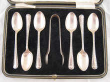 A cased set of six teaspoons and tongs