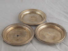 A set of four white metal tests