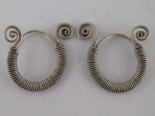 A pair of silver earrings of ancient