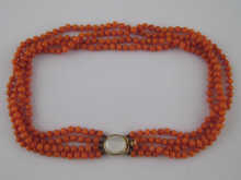 A four strand coral bead necklace