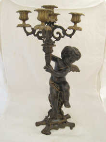 A bronze cherub holding a five
