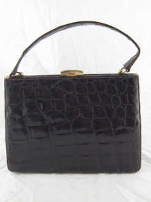 A lady's dark crocodile skin handbag