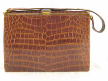 A ladys tan crocodile skin handbag