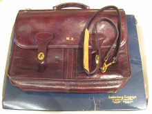 A maroon leather briefcase with pockets