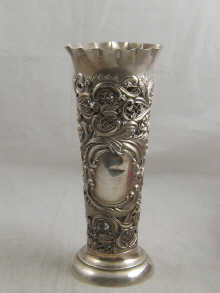 A silver pierced repousse vase
