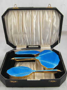 An Art Deco blue enamel three piece 14ea02