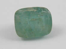 A loose polished cabochon emerald