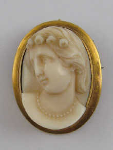 A finely carved ivory cameo set in yellow