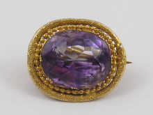 A yellow metal (tests 18 ct gold) amethyst