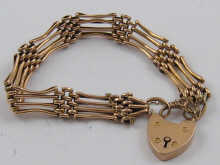 A 9 ct gold gate bracelet with 14ea39