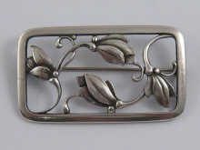 A rectangular silver floral brooch by