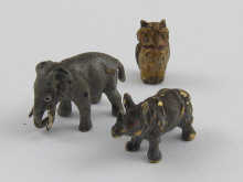 Three miniature bronze animals being