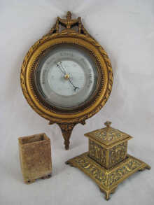 A wall mounted aneroid barometer