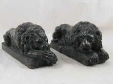 A pair of recumbent lions in dark green