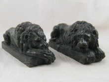 A pair of recumbent lions in dark 14eaca