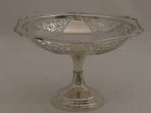 A pierced silver cake stand with