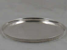 A plain silver circular tray 29