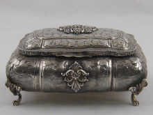 A silver rectangular bombe casket
