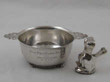 A silver two handled porringer on four