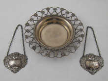 A silver wine coaster the rim with