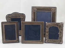Five silver photo frames largest