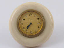 A small gilt metal strut clock mounted