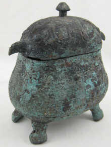 An bronze oval vessel and cover