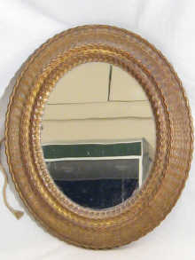 An oval mirror with original plate