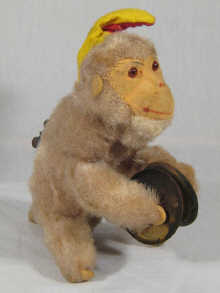 A mechanical monkey toy playing 14ebb9