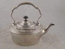 A silver kettle with ivory insulators