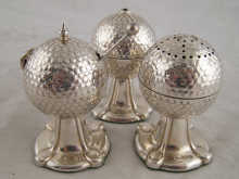 A three piece silver cruet designed