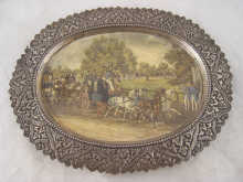 A white metal oval dish with paper print