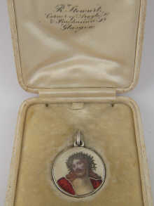 A silver pendant medallion the