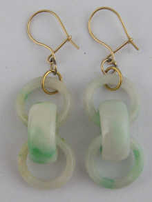 A pair of jade earrings carved