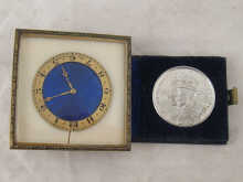 A bedside clock with blue enamel dial