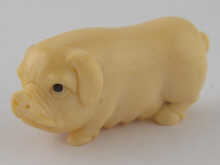 An ivory netsuke of a pig approx. 4cm