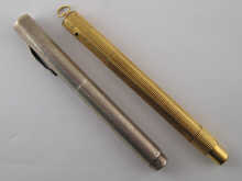 A gilt metal fountain pen with retractable