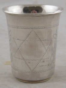 A silver beaker with engraved star of