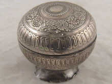 A white metal hemispherical bowl