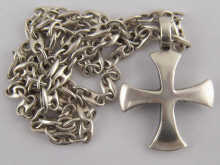 A white metal (tests silver) cross and