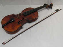 A violin with ebony pegs and stringing