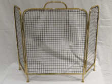 A three fold brass mesh fireguard