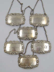 Six silver wine labels ranging 14f210
