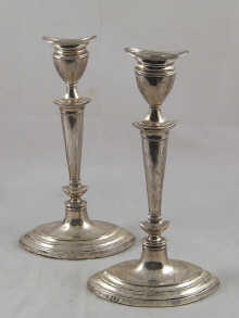 A pair of Adam style silver candlesticks