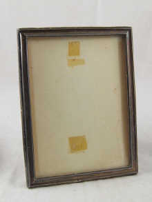 A silver picture frame with oak